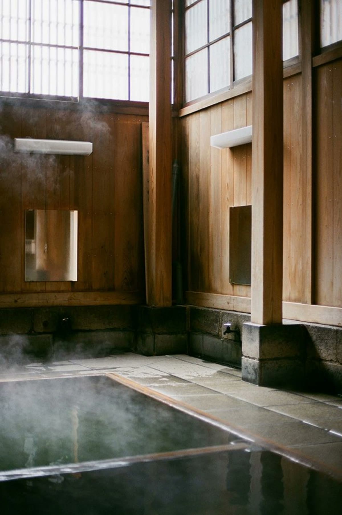 Steam rising from a wooden bathhouse tub